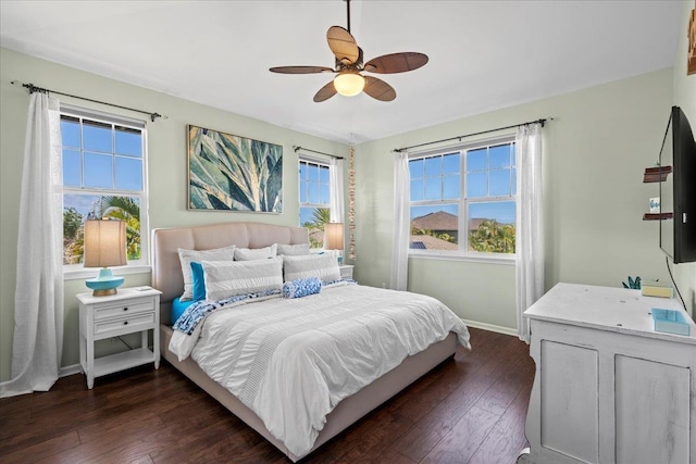 bedroom with dark wood-style floors, baseboards, and a ceiling fan