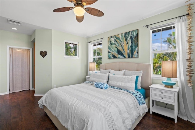 bedroom featuring a ceiling fan, baseboards, visible vents, and dark wood-style flooring