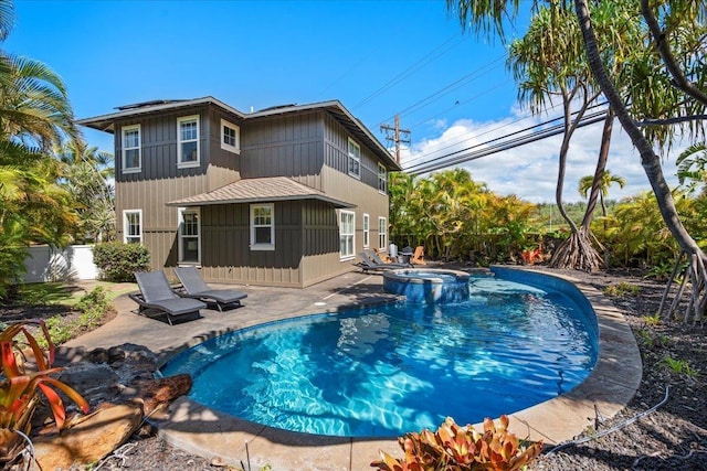 view of pool featuring a pool with connected hot tub, a fenced backyard, and a patio