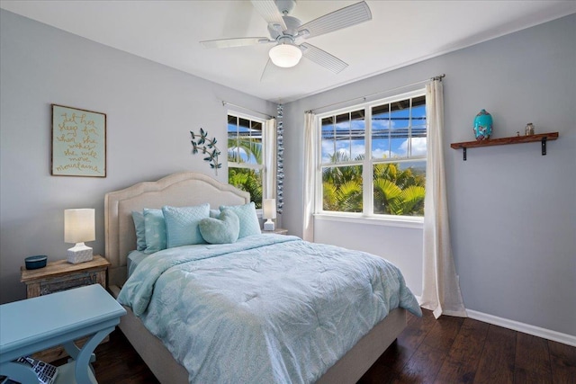 bedroom featuring dark wood-type flooring, ceiling fan, and baseboards