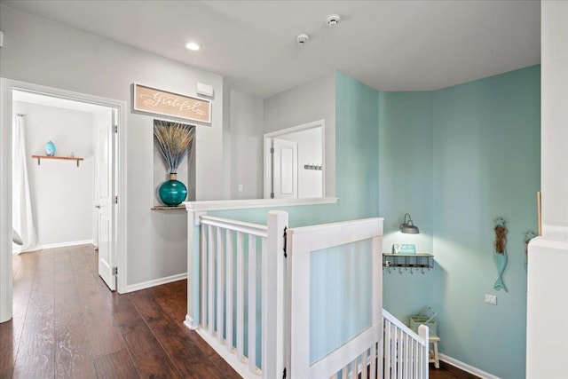 hall featuring recessed lighting, dark wood finished floors, an upstairs landing, and baseboards