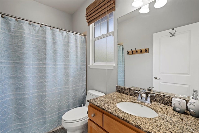 bathroom featuring toilet and vanity