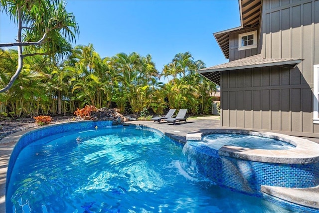 view of pool with a pool with connected hot tub