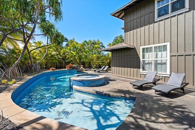 view of pool with a patio area and a pool with connected hot tub