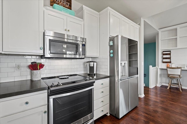 kitchen featuring dark wood-style floors, tasteful backsplash, dark countertops, appliances with stainless steel finishes, and white cabinets