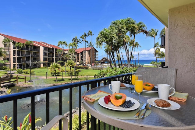 balcony featuring a water view