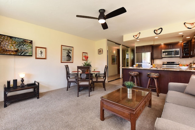 living room with ceiling fan and carpet