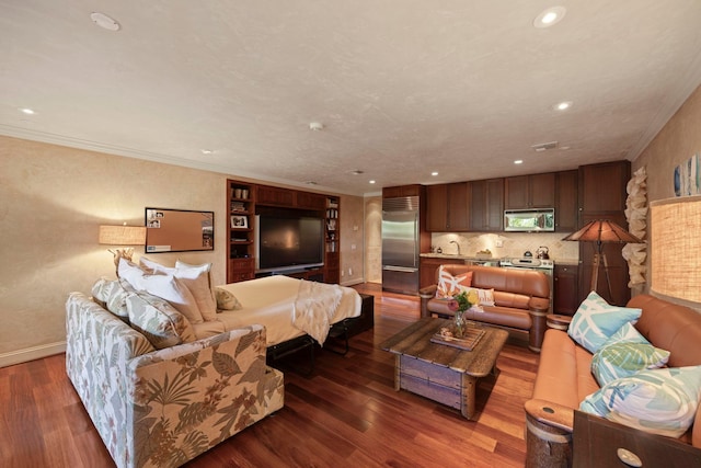 living room with sink, ornamental molding, and hardwood / wood-style floors