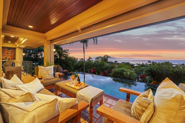 patio terrace at dusk featuring an outdoor living space