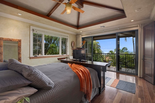 bedroom featuring crown molding, dark hardwood / wood-style floors, access to exterior, ceiling fan, and a raised ceiling