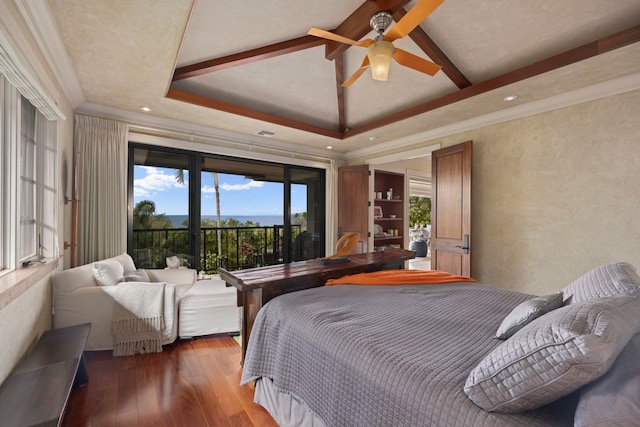 bedroom with dark hardwood / wood-style flooring, access to exterior, ceiling fan, and a raised ceiling