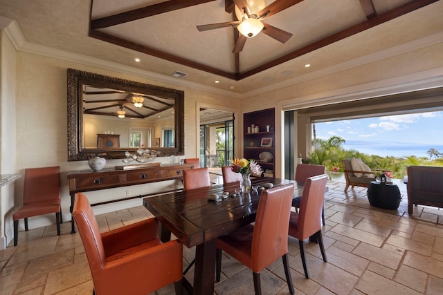 tiled dining space featuring ceiling fan, crown molding, and a tray ceiling