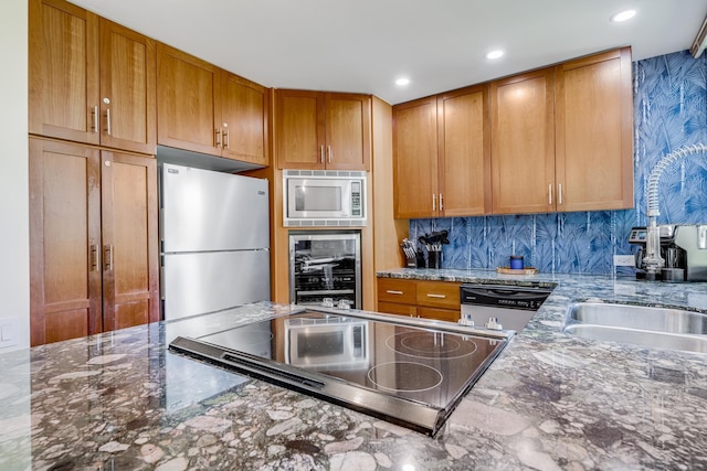 3200 Wailea Alanui Dr Unit 2105, Kihei, HI 96753 - kitchen with appliances with stainless steel finishes, wine cooler, dark stone countertops, brown cabinetry, and recessed lighting