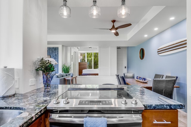 3200 Wailea Alanui Dr Unit 2105, Kihei, HI 96753 - kitchen with stainless steel electric stove, ceiling fan, open floor plan, dark stone countertops, and recessed lighting