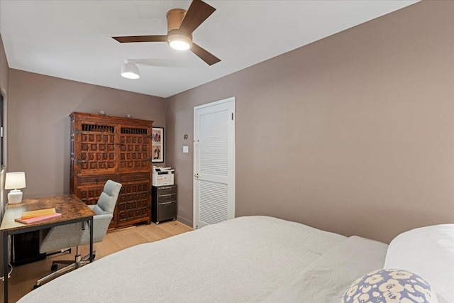 bedroom with light hardwood / wood-style floors and ceiling fan