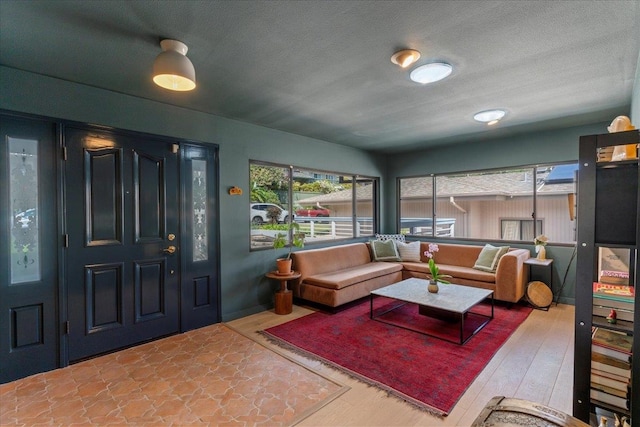 living room with a wealth of natural light, hardwood / wood-style floors, and a textured ceiling