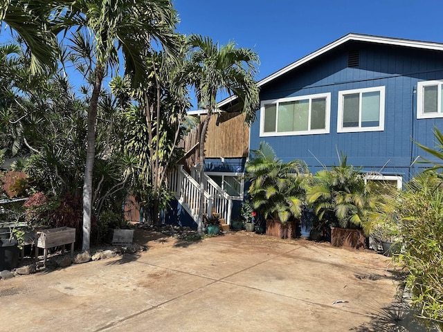 view of home's exterior featuring stairs