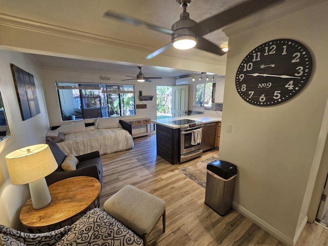 interior space with light countertops, light wood-style flooring, ornamental molding, stainless steel range with electric stovetop, and a peninsula