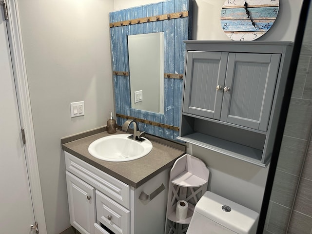 bathroom featuring vanity and toilet