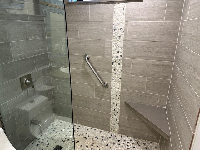 full bathroom with a tile shower