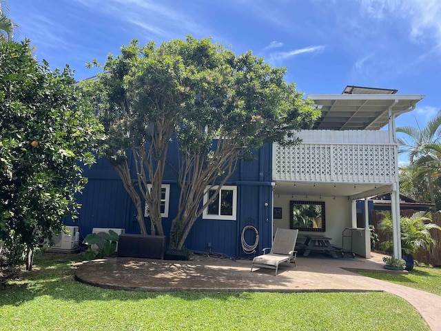 back of house featuring a yard and a patio