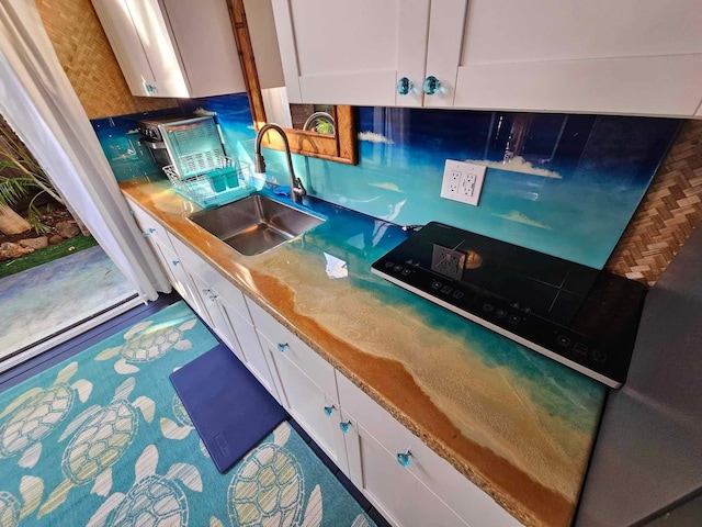 kitchen with white cabinetry and a sink