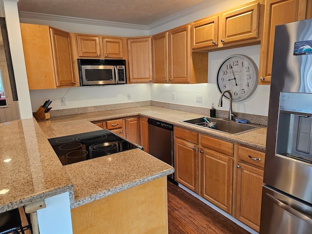 kitchen featuring light stone counters, ornamental molding, dark wood-type flooring, stainless steel appliances, and a sink