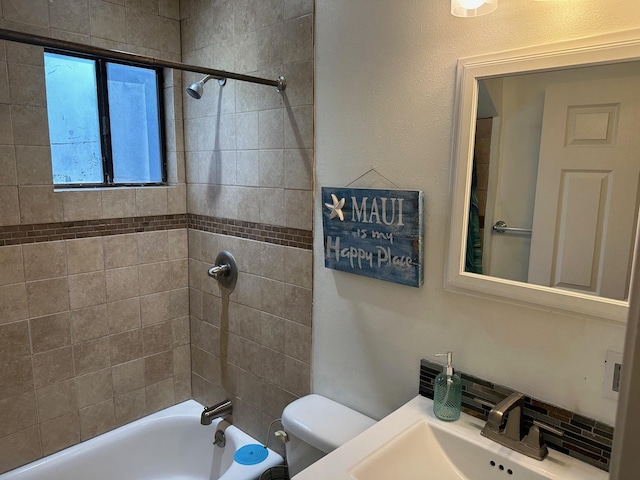 bathroom featuring tub / shower combination, a sink, and toilet