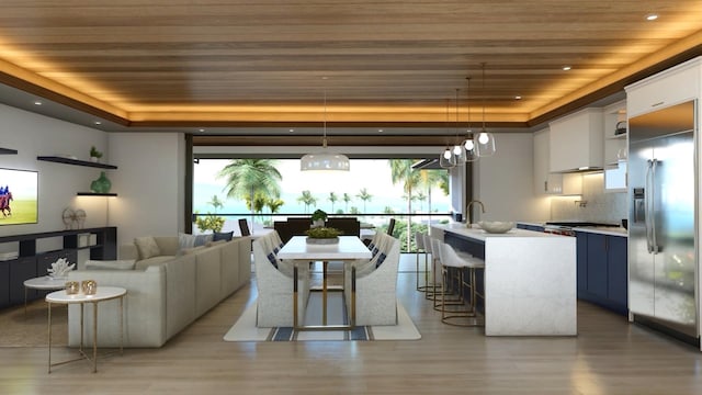 living room featuring hardwood / wood-style flooring, a chandelier, wood ceiling, and a tray ceiling