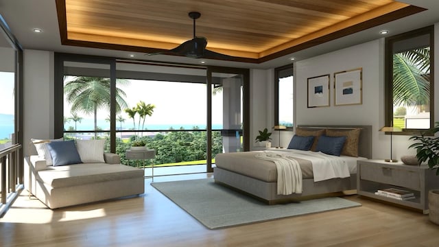 bedroom featuring light wood-type flooring, access to outside, a raised ceiling, and floor to ceiling windows