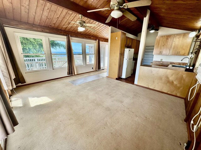 interior space featuring ceiling fan, carpet floors, sink, wood ceiling, and white refrigerator