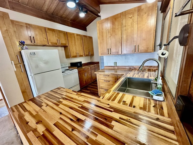 kitchen with lofted ceiling with beams, sink, white appliances, butcher block counters, and wooden ceiling