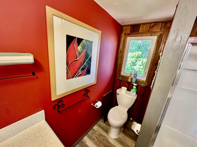 bathroom featuring hardwood / wood-style floors and toilet