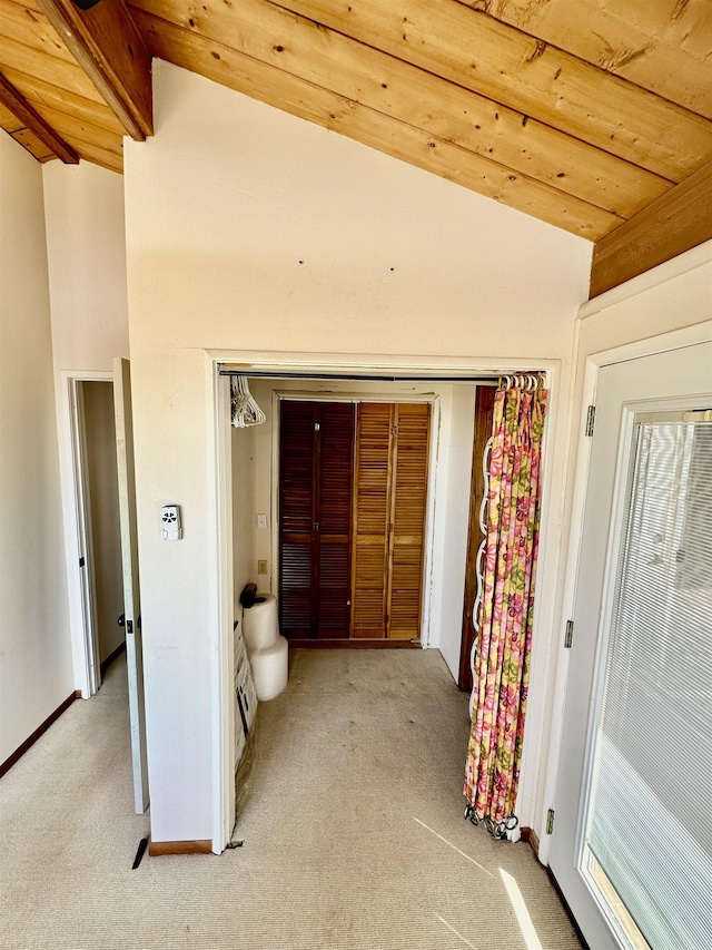 hallway featuring wooden ceiling, light colored carpet, and vaulted ceiling with beams