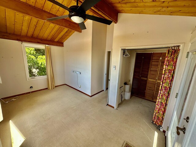 unfurnished bedroom with light carpet, vaulted ceiling with beams, a closet, ceiling fan, and wooden ceiling