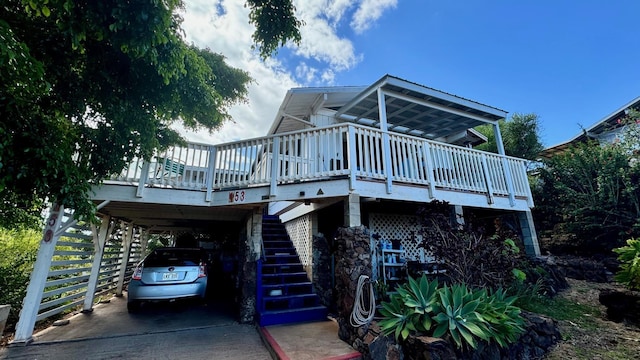 exterior space featuring a wooden deck and a carport