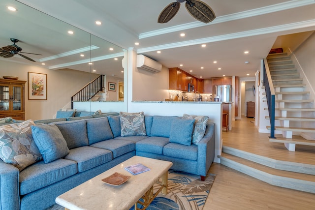 living room featuring light hardwood / wood-style floors, an AC wall unit, ceiling fan, and ornamental molding