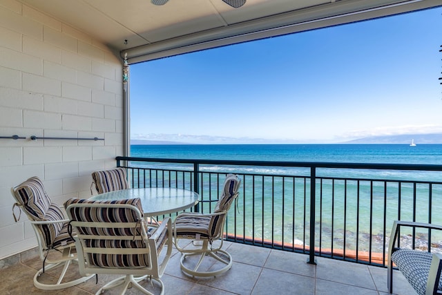 balcony with a water view and a beach view