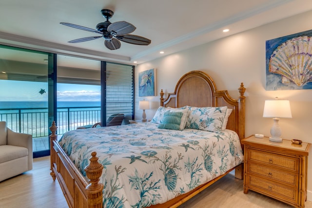 bedroom with access to outside, light wood-type flooring, a water view, and ceiling fan