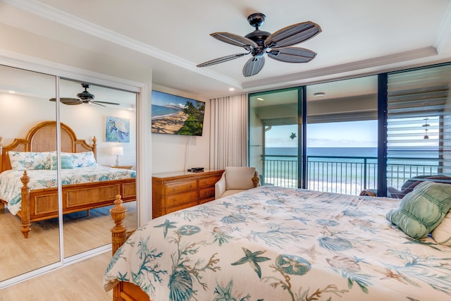 bedroom with access to exterior, ceiling fan, a closet, and light wood-type flooring