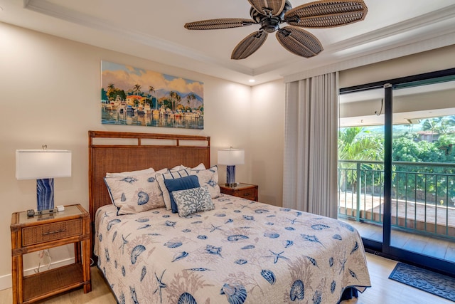 bedroom with ceiling fan, light hardwood / wood-style floors, access to outside, and a tray ceiling