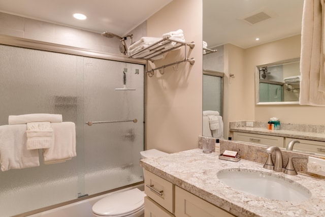 full bathroom with toilet, combined bath / shower with glass door, and vanity