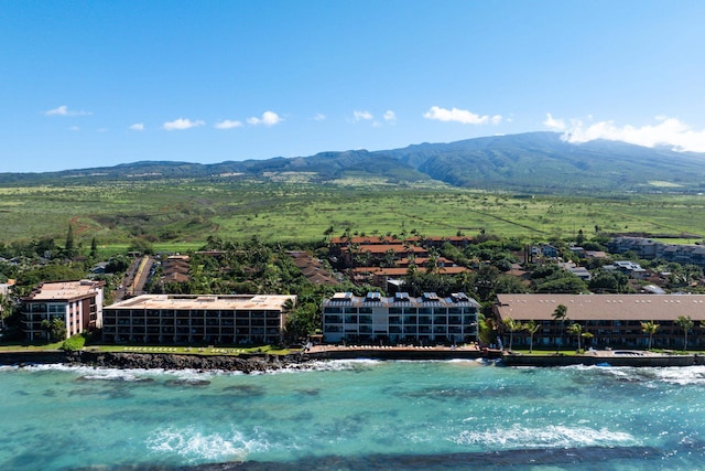 birds eye view of property with a water and mountain view