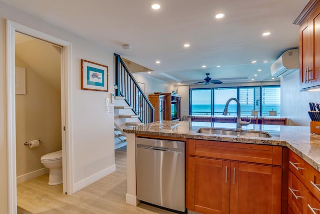 kitchen with ceiling fan, dishwasher, sink, light hardwood / wood-style flooring, and a wall mounted AC