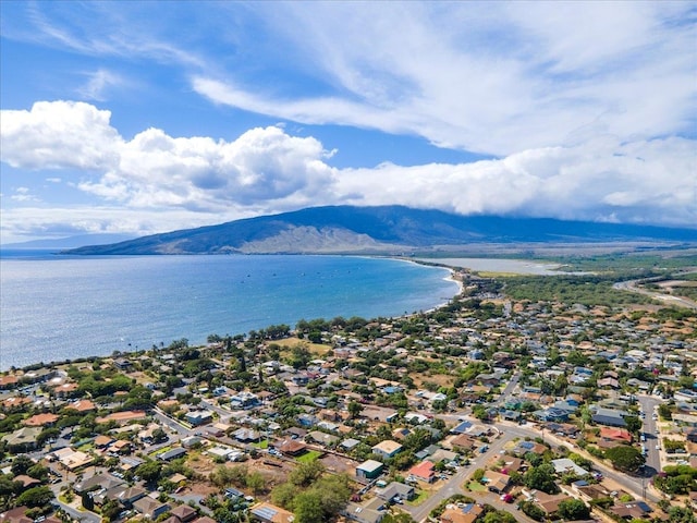 birds eye view of property with a water and mountain view