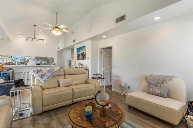 living room featuring high vaulted ceiling, ceiling fan, and hardwood / wood-style flooring