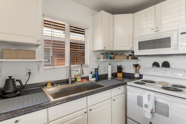 kitchen featuring white cabinets, sink, and white appliances