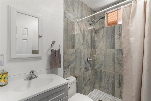 bathroom with walk in shower, vanity, and toilet