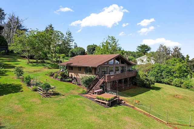 back of property featuring a deck and a yard