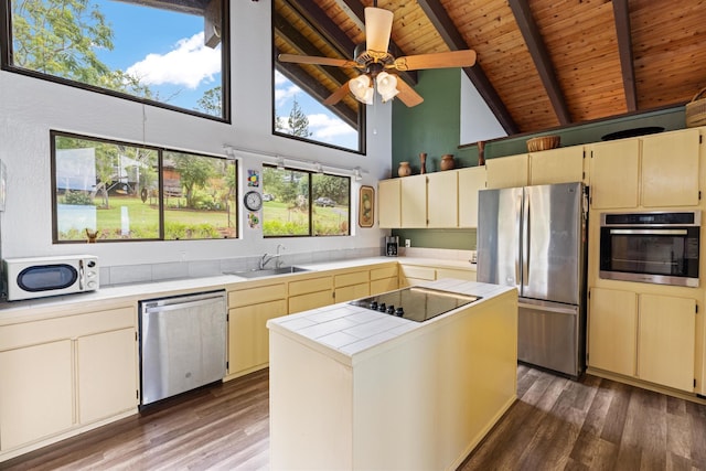 kitchen with high vaulted ceiling, beamed ceiling, stainless steel appliances, ceiling fan, and sink